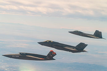 XQ-58 Valkyrie flying in formation with F-22 Raptor and F-35A Lightning II
