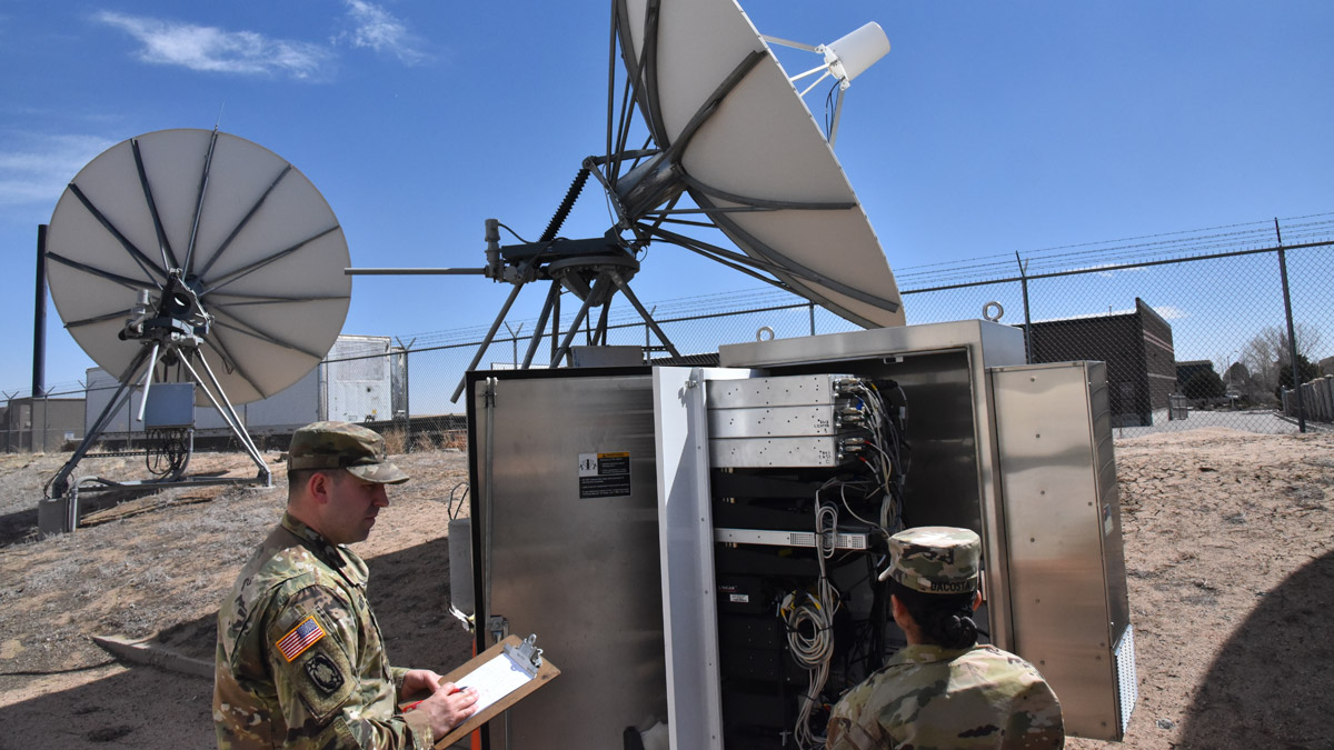Staff Sgt. Travis Matzdorf assesses Pvt. 2nd Class Amayah Dacosta on her explanation of data flow through a JTAGS antenna system at a training facility in Colorado Springs.