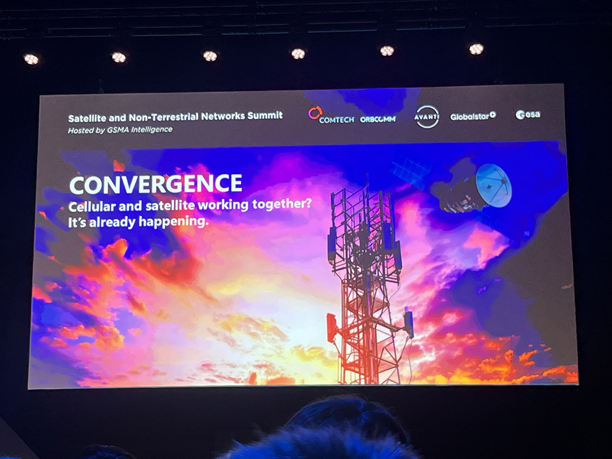 A slide at a conference proclaiming 'CONVERGENCE' between cellular and satellite networks, stating it's already happening, with colorful background and sponsors' logos.