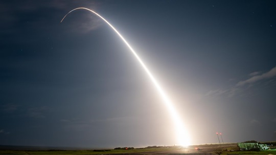 A long-exposure image captures the bright trail of a medium-range ballistic missile launched from the Pacific Missile Range Facility in Kauai, Hawaii during a U.S. Missile Defense Agency test on March 30, 2023.