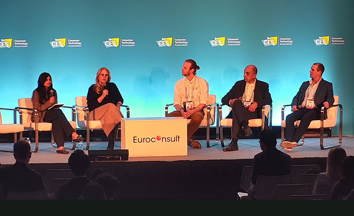 Four panelists are seated onstage at a CES event discussing satellite-to-cellular device connectivity.