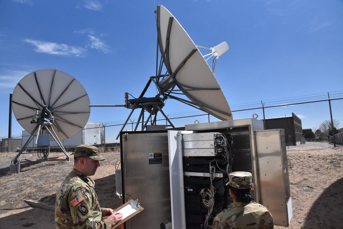 Staff Sgt. Travis Matzdorf assesses Pvt. 2nd Class Amayah Dacosta on her explanation of data flow through a JTAGS antenna system at a training facility in Colorado Springs.