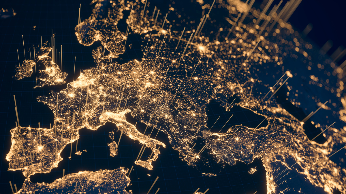 A satellite view of Europe at night, with city lights illuminating the continent and data beams rising from major cities.