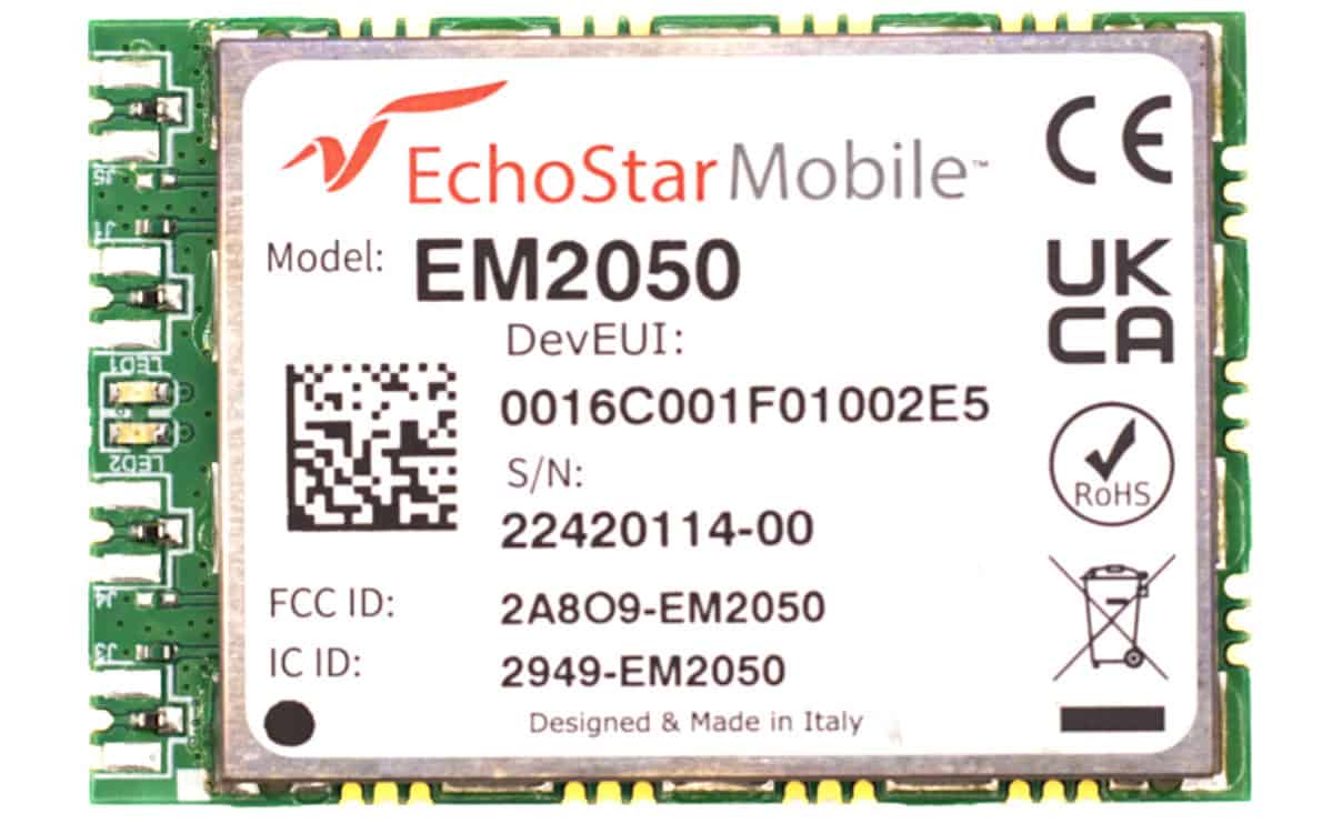 A close-up image of an EchoStar Mobile EM2050 cellular IoT module, displaying its model number, DevEUI, serial number, FCC ID, IC ID, and various certification marks. (Source EchoStar Mobile)