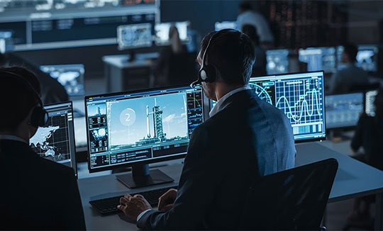 Person wearing a headset working at a workstation