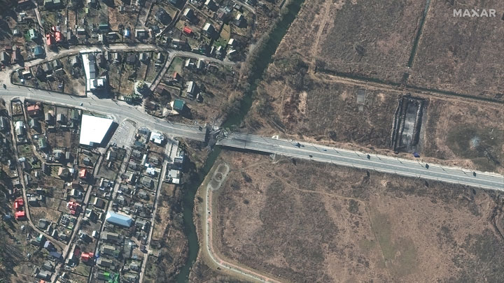 This satellite image taken Feb. 27, 2022, by Maxar Technologies shows a damaged bridge and road on the approach toward Kyiv.