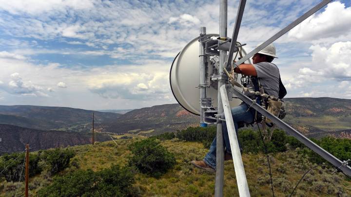 Worker working on a satellite dish