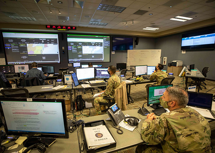 In this Oct. 31, 2022, photo, U.S. Air Force Lt. Col. Mike Johnson, 26th Space Aggressor Squadron space control operator, performs a feed swap on an antenna during a CRIMSON SKIES exercise to train MILSATCOM operators.