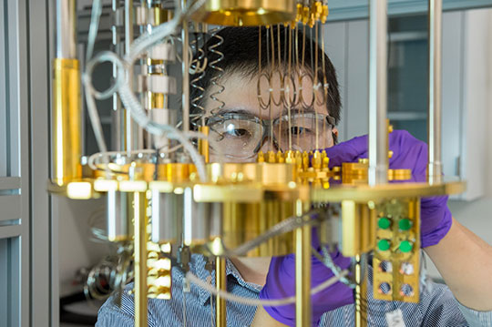 Argonne scientist Dafei Jin observes a dilution refrigerator, a cryogenic cooling device for materials used for quantum computing