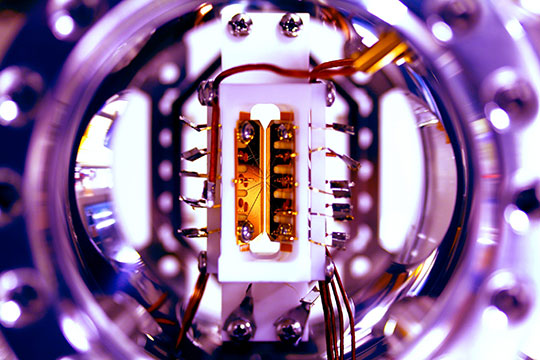 Atomic ions, held in place by devices like the blade trap above, are one of the most promising experimental platforms for performing quantum simulations