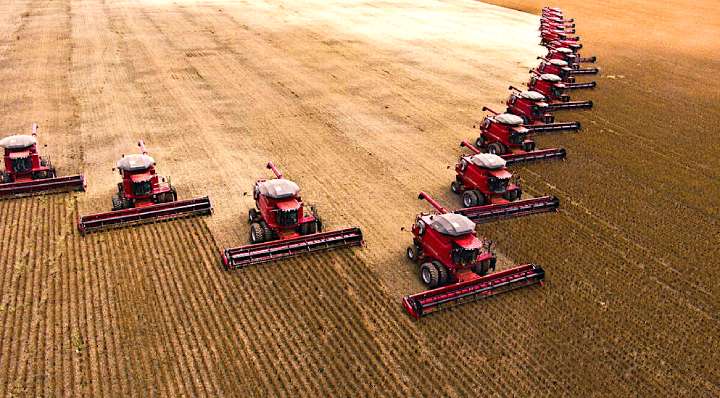 Tractors harvesting crops