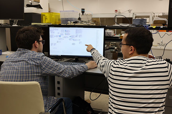 Students at Virginia Tech work on the hardware-in-the-loop test bed that emulates the changing connectivity of a mega-constellation at scale.