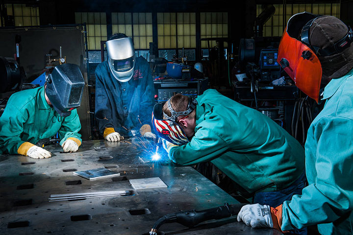 Numerous U.S. industries are on-shoring manufacturing and elevating demand for skilled workers. A senior welder and engineering technician gives a tutorial to college students at NASA Glenn Research center.