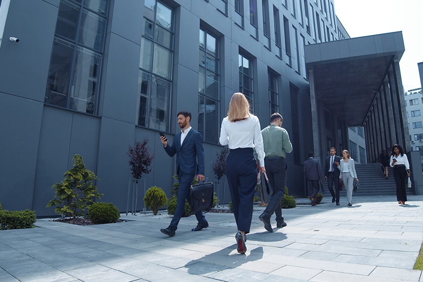Business professionals walking outside of corporate building